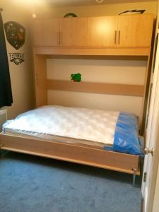 Queen size Murphy Bed with cabinets on top.