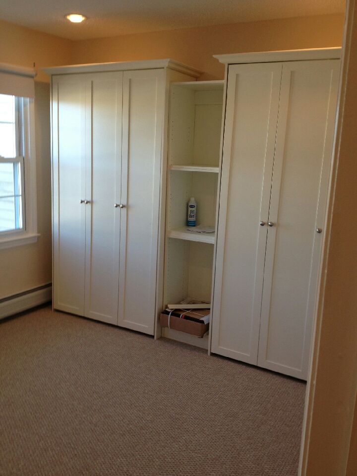Double twin Murphy beds with raised panel and crown molding in Pure Wthite finish