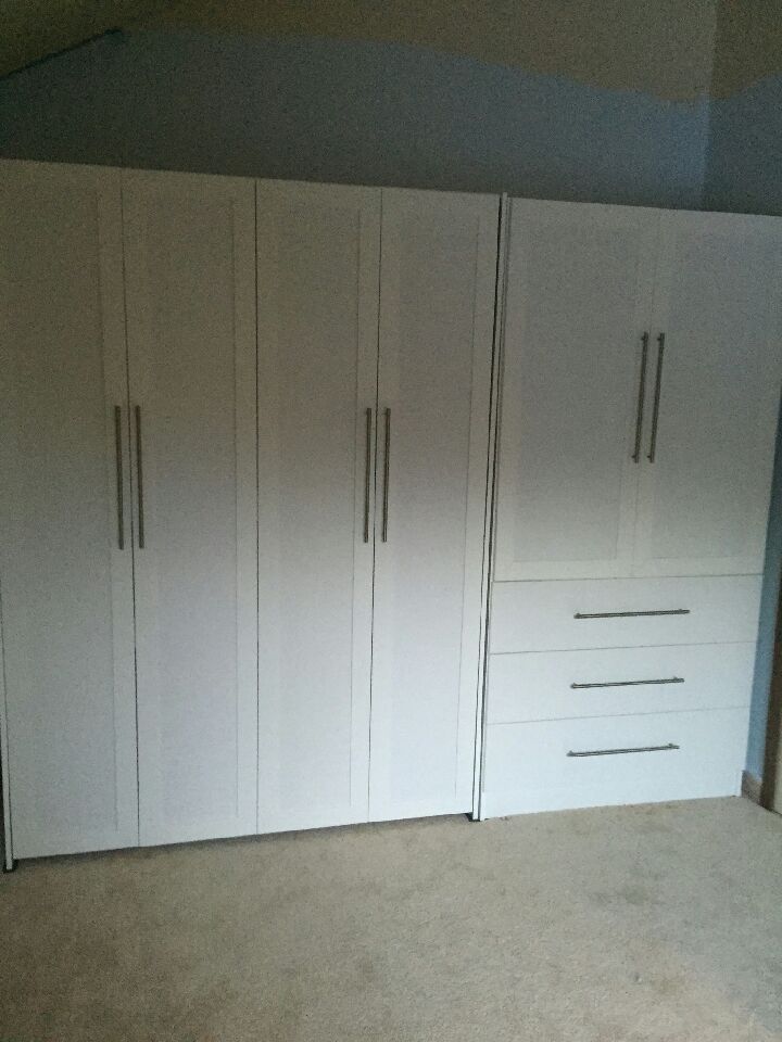 Full-size vertical bed with a custom cabinet to match raised panels