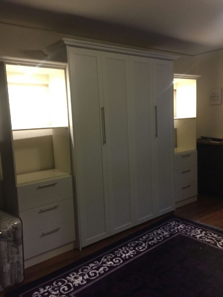 Queen-size vertical Murphy Bed with custom lights and bookcases with drawers